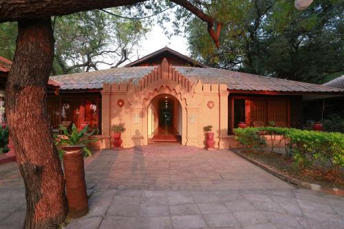 a house with a brick walkway in front of it at KMA Bagan Hotel River View in Bagan