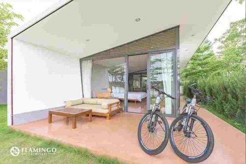 a bike parked on the patio of a house at FLAMINGOS Villa Happy BT in Ngọc Quang
