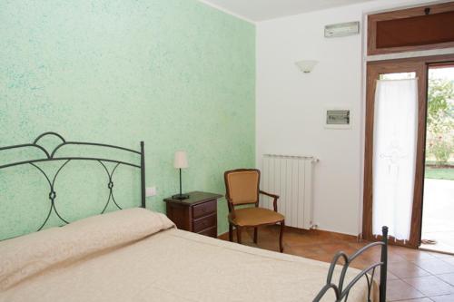 una camera con letto, scrivania e sedia di Agriturismo di Paterno a Sarzana