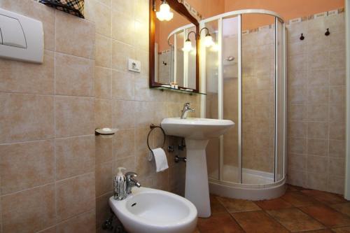 La salle de bains est pourvue d'un lavabo, d'une douche et de toilettes. dans l'établissement Agriturismo di Paterno, à Sarzana