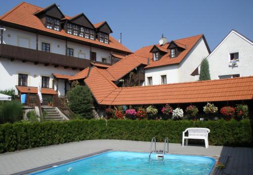 a house with a swimming pool in front of a building at Dalmo in Sedlec