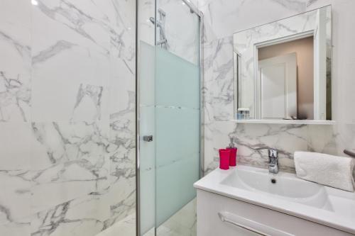 a bathroom with a shower and a sink and a mirror at 66 - Atelier Fidélité Paris in Paris