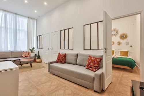un salon avec un canapé et un lit dans l'établissement 66 - Atelier Fidélité Paris, à Paris
