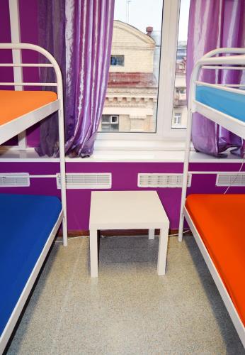 a room with two bunk beds and a window at City Center Hostel in Kyiv