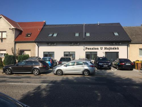 a group of cars parked in front of a building at Penzion U Hujňáků in Rohatec