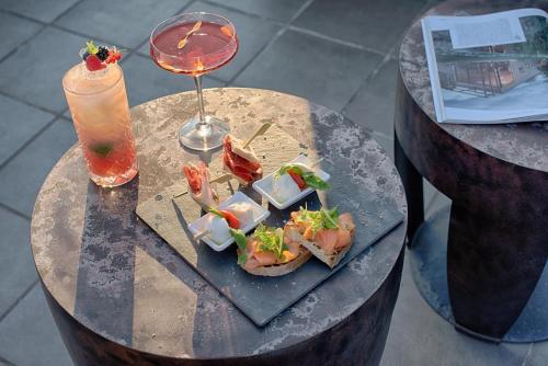 a table with a plate of food and a drink at Radisson Blu Hotel Milan in Milan