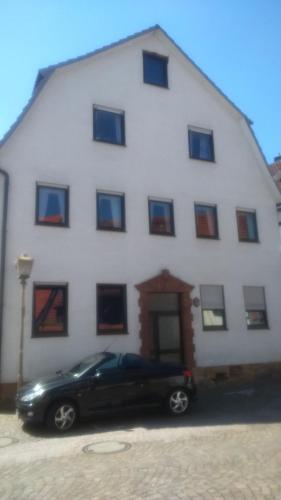 a black car parked in front of a white building at Ferienwohnung St. Wigbert in Fritzlar