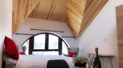 a bedroom with a bed and a large window at Gîtes du Golf in Sart-Dames-Avelines