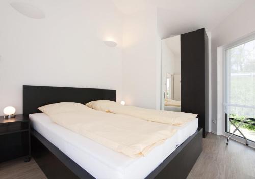 Säng eller sängar i ett rum på Ferienhäuser am Hainich