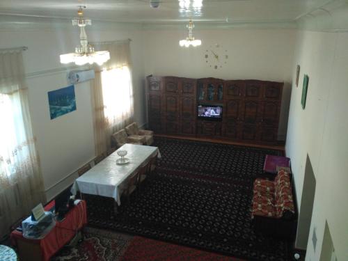 an overhead view of a living room with a table at Western house in Qorowul