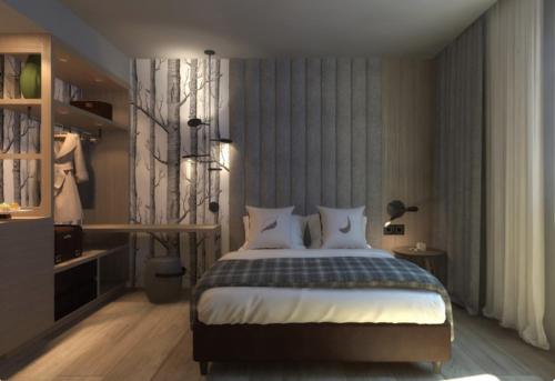 a bedroom with a bed and a desk at Ròseo Euroterme Wellness Resort in Bagno di Romagna