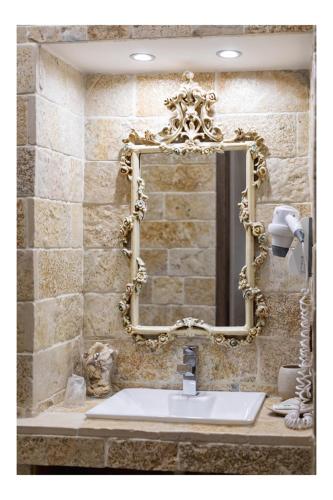 a bathroom with a mirror and a sink at Dependance Ludovica in Termoli