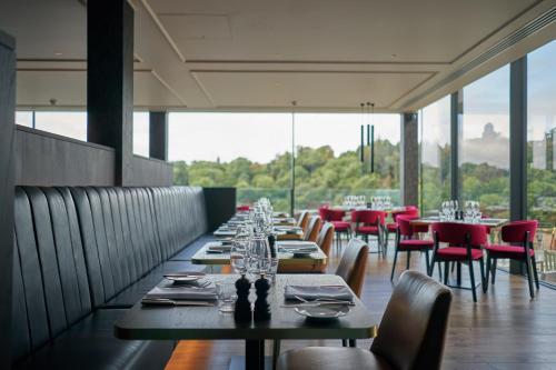 a dining room with tables and chairs and windows at Avon Gorge by Hotel du Vin in Bristol