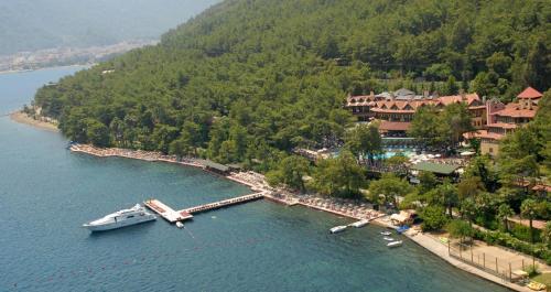 a boat is docked at a dock in the water at Marmaris Park Hotel in Marmaris