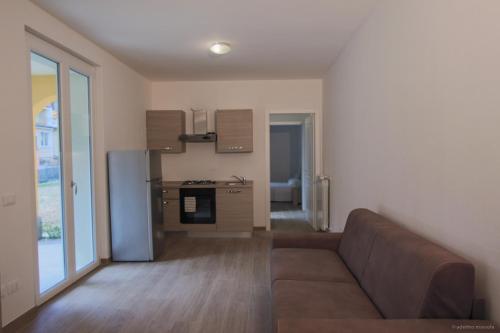 a living room with a couch and a kitchen at Santa Caterina in Levanto