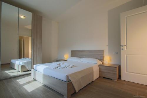 a bedroom with a white bed and a mirror at Santa Caterina in Levanto