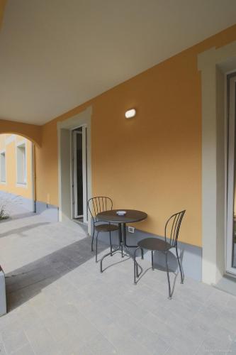 a patio with a table and chairs on a porch at Santa Caterina in Levanto