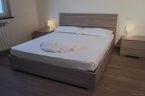 a bedroom with a large bed with white sheets and pillows at Santa Caterina in Levanto