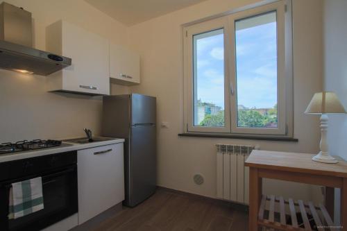 a kitchen with a stainless steel refrigerator and a window at Santa Caterina in Levanto