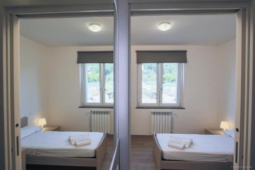 a room with two beds and two windows at Santa Caterina in Levanto