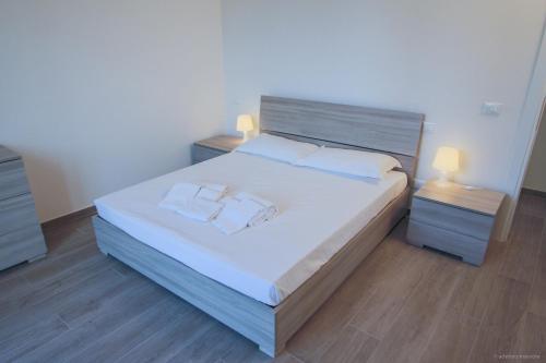 a bedroom with a large bed with two night stands at Santa Caterina in Levanto