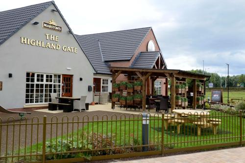 a building with a table and chairs in front of it at Highland Gate, Stirling by Marston's Inns in Stirling