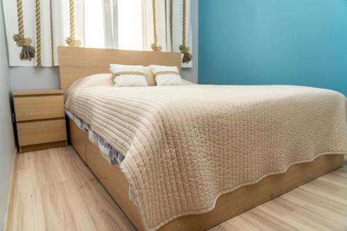- une chambre avec un grand lit et une tête de lit en bois dans l'établissement Apartament Widok Cieplice, à Jelenia Góra