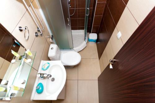 a small bathroom with a toilet and a sink at HostGost at Kraljevi Čardaci in Kopaonik