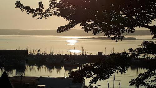 a sunset over a harbor with boats in the water at Hillside Landing B&B in Digby