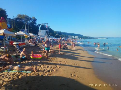 a group of people on a crowded beach at ApartHotel Dom in Odesa