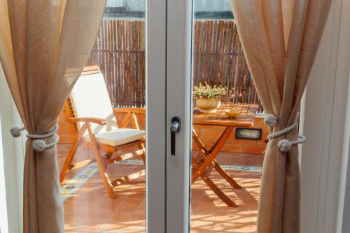 an open door to a balcony with a table and chairs at Vista Mare B&B in Sorrento