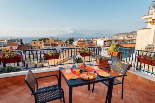 a table and chairs with food on a balcony at Vista Mare B&B in Sorrento