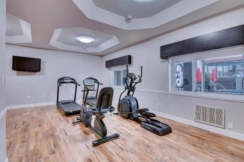 a gym with treadmills and ellipticals in a room at Orangewood Inn and Suites Midtown in Austin