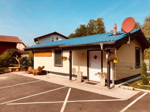a parking lot with a teddy bear sitting in front of a building at Ferienhaus Little Rennsteig in Eisenach
