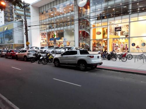 a row of cars parked in front of a building at Apart Hotel Quartier Latin in Vitória
