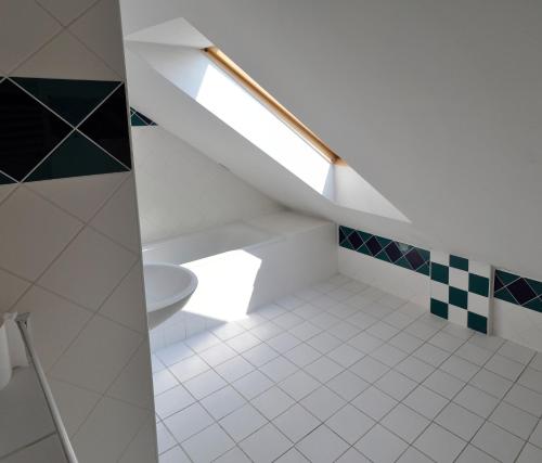 a bathroom with a toilet and a staircase at Apartmán Belá in Spišská Belá