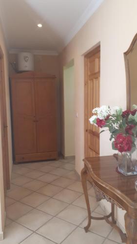 a room with a table with a vase of flowers on it at Apartamentos CHRISTINA in Benicàssim