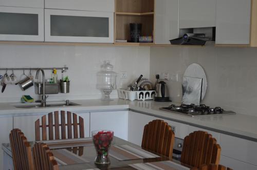 a kitchen with a table and chairs and a stove at Beach Mount Apartment (Blue Ocean Apartment) in Mount Lavinia