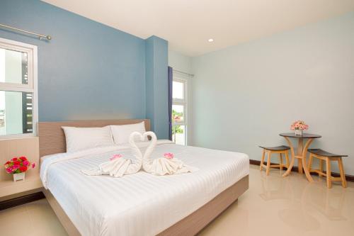 a bedroom with a bed with two towels on it at Je T'aime Hotel in Trang