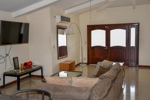 a living room with a couch and a table at Jaco Sol Quadplex 11A in Jacó