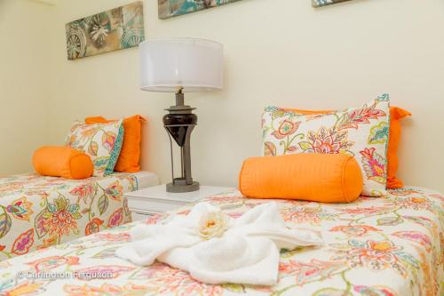 a bedroom with a bed with a robe on it at Turtle Beach Towers in Ocho Rios