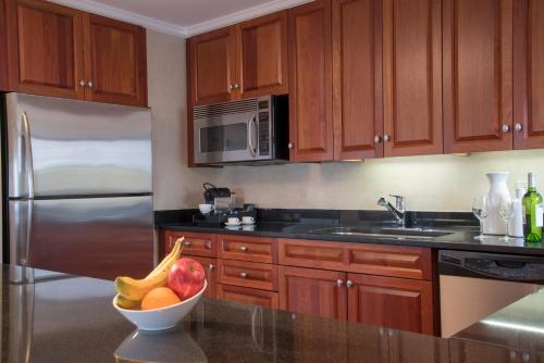 a kitchen with a bowl of fruit on a counter at The Warwick Hotel Rittenhouse Square Philadelphia in Philadelphia