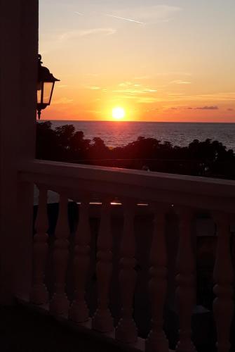 a sunset from the balcony of a condo at Queen Apartments & Rooms in Dobra Voda