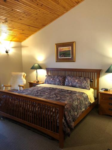 a bedroom with a large bed and a wooden ceiling at ReWild Ranch LLC in Sargent