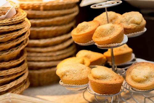 a bunch of muffins on a stand in a bakery at Punta Sal Suites & Bungalows Resort in Canoas De Punta Sal