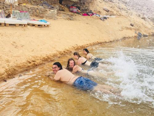 a group of people laying in the water at david hostel in Aswan