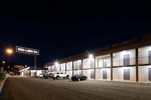 a building with cars parked in a parking lot at night at Red Lion Inn & Suites Tucson Downtown in Tucson