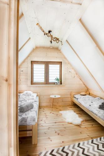 a room with two beds and a table at Fiedorówka in Zakopane