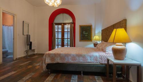 a bedroom with a bed and a lamp on a table at Trendy Apartment in Casco Viejo in Panama City