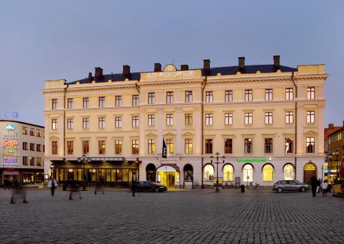 a large building with people walking in front of it at Elite Stora Hotellet Linköping in Linköping